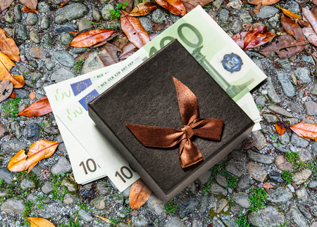Gift box with one hundred euro banknotesの写真素材