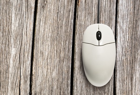 Computer mouse on wooden background in closeupの写真素材