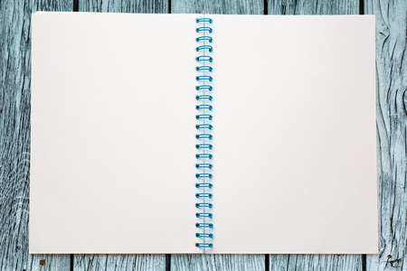 One open blank notebook on wooden backgroundの写真素材