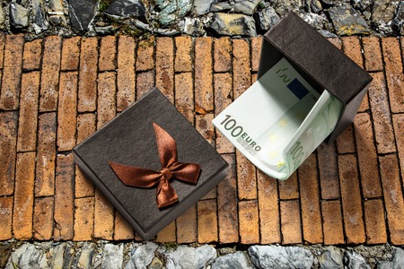 Gift box with one hundred euro banknotesの写真素材