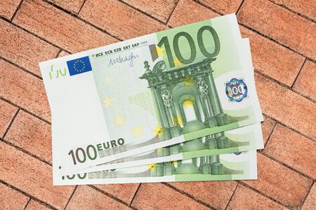 One hundred euro banknotes on brick backgroundの写真素材