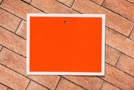 Blank red card on the brick backgroundの写真素材