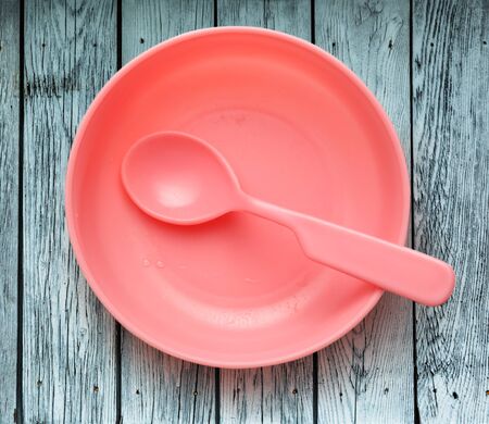 Pink plastic tableware dish, spoon and forkの写真素材