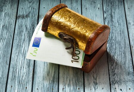 Treasure chest with one hundred euro banknoteの写真素材