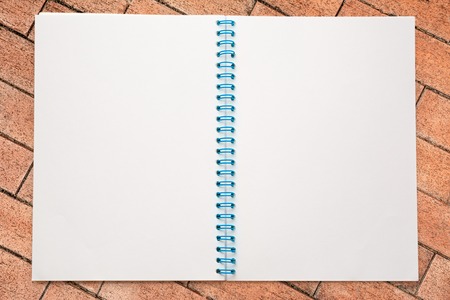 One open blank notebook on wall backgroundの写真素材