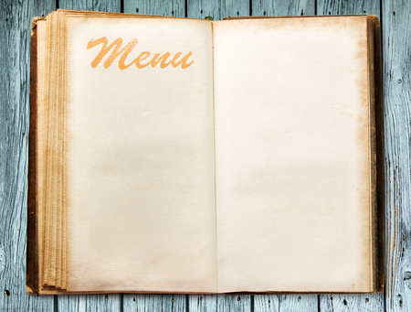 One blank vintage menu book on wooden backgroundの写真素材