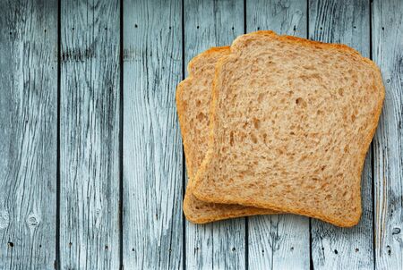 Two bread slices on the wooden backgroundの写真素材