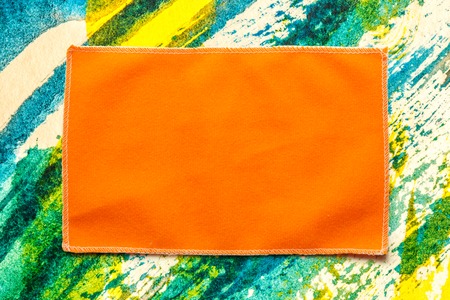 Orange microfiber cloth for glasses in closeup