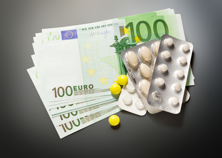 One hundred euro banknotes and pills closeupの写真素材