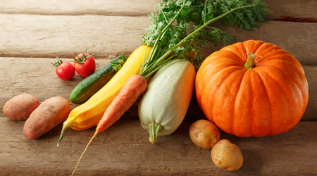 Fresh vegetables on wooden background in closeupの写真素材