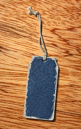Blue blank paper label on wooden backgroundの写真素材
