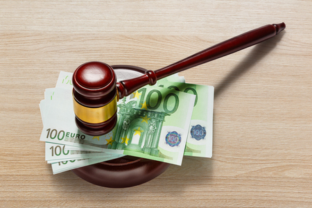 Wooden judge's gavel and one hundred euro banknotesの写真素材