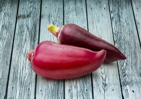 Red paprika pepper on wooden background closeupの写真素材