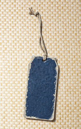 Blue blank paper label on textile backgroundの写真素材