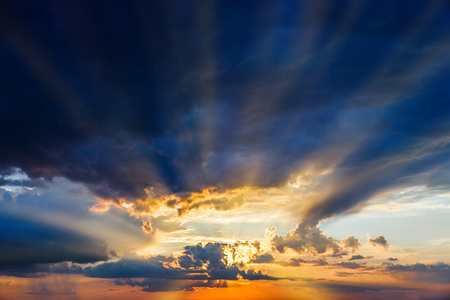 Blue sky with light through clouds before sunsetの写真素材