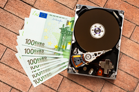 One hundred euro banknotes and hardisk in closeupの写真素材