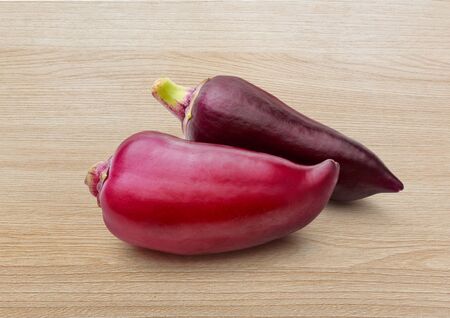 Red paprika pepper on wooden background closeupの写真素材