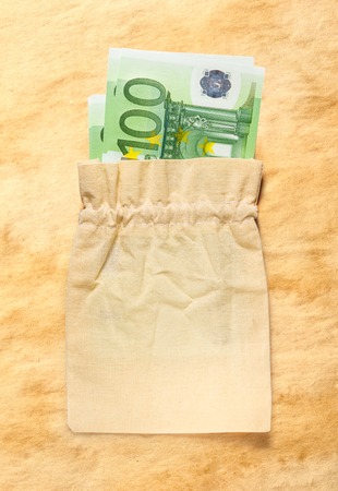 One hundred euro banknotes in linen sack closeupの写真素材