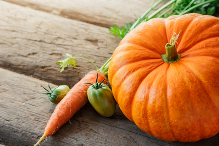 Fresh vegetables on wooden background in closeupの写真素材