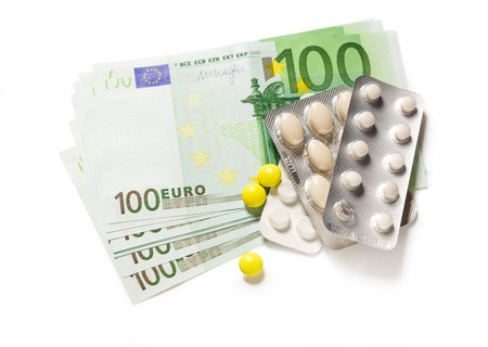 One hundred euro banknotes and pills closeupの写真素材