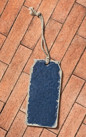 Blue blank paper label on brick backgroundの写真素材