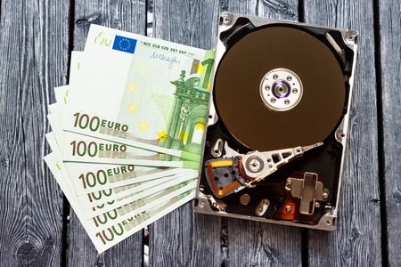 One hundred euro banknotes and hardisk in closeupの写真素材