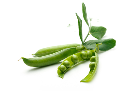 Fresh green peas with leaves on whiteの写真素材
