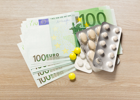 One hundred euro banknotes and pills closeupの写真素材