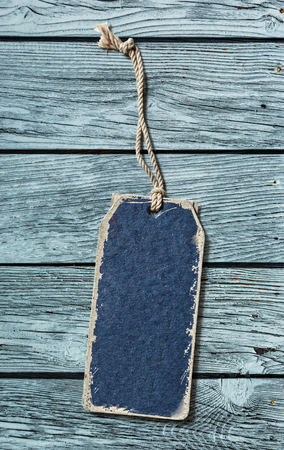 Blue blank paper label on wooden backgroundの写真素材