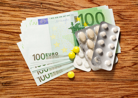 One hundred euro banknotes and pills closeupの写真素材