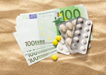 One hundred euro banknotes and pills closeupの写真素材