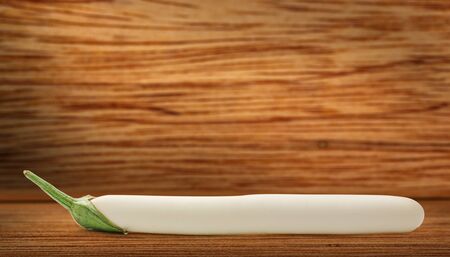 One fresh eggplant on the wooden backgroundの写真素材