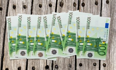 One hundred euro banknotes on wooden backgroundの写真素材