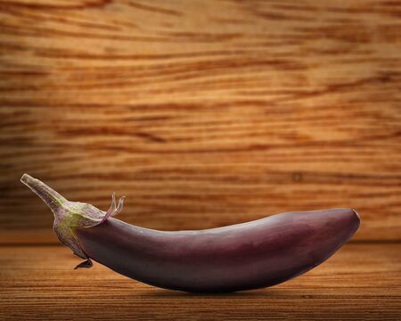 One fresh eggplant on the wooden backgroundの写真素材