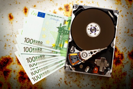 One hundred euro banknotes and hardisk in closeupの写真素材