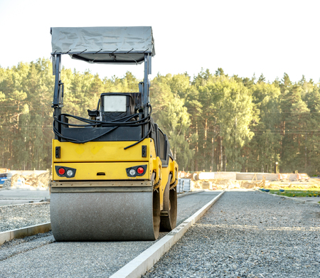 Road roller working at road construction site
