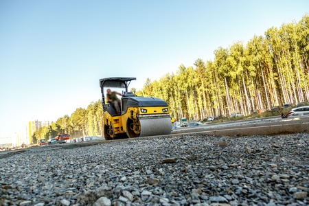 Road roller working at road construction site