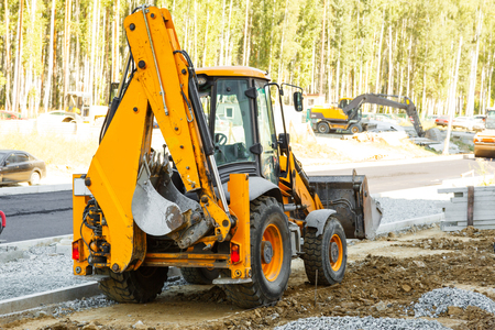 Yellow bulldozer working on the city roadの写真素材