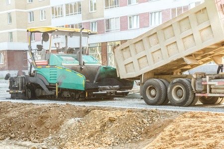Asphalt-placing machine working on the city roadの写真素材