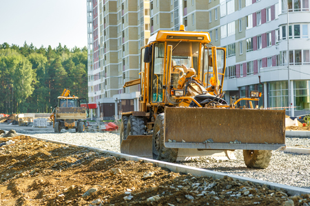 Grader working outside on road construction in summerの写真素材