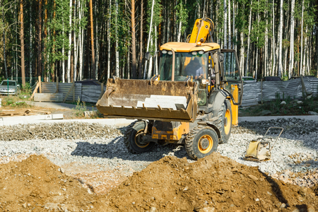 Grader working outside on road construction in summerの写真素材