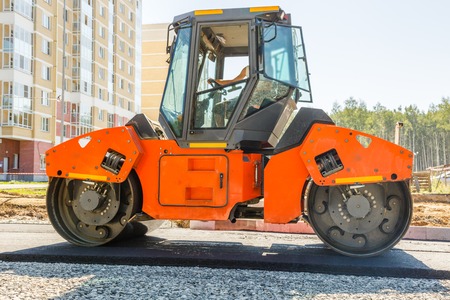 Road roller working at road construction site