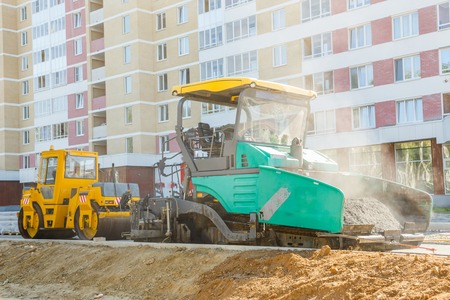 Asphalt-placing machine working on the city road