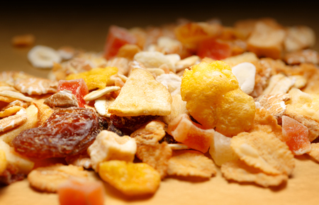 Heap of fresh musli with raisin on paper backgroundの写真素材