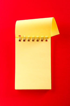 Blank open notebook on the red backgroundの写真素材