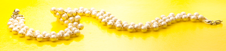Necklace with golden chain and white beadsの写真素材