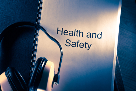 Health and safety document with earphones in toningの写真素材