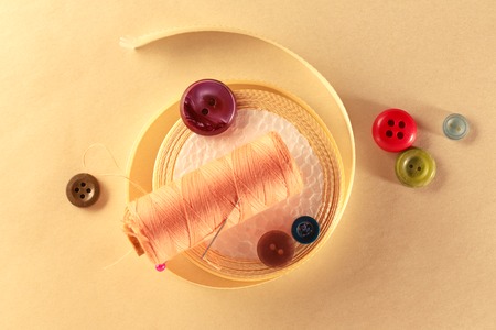 Colourful buttons and ribbon roll in closeup