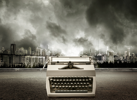 Old-fashioned typewriter with latin alphabet on city viewの写真素材