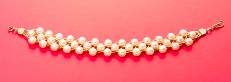 Wristband with golden chain and white beadsの写真素材